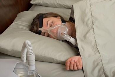 woman using a CPAP machine for sleep apnea