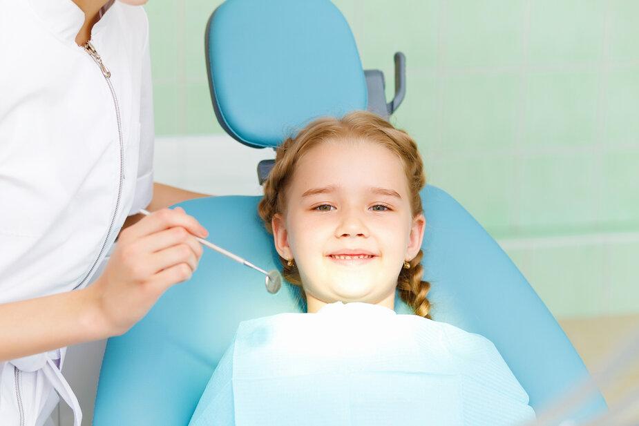 young girl sitting in dental chair