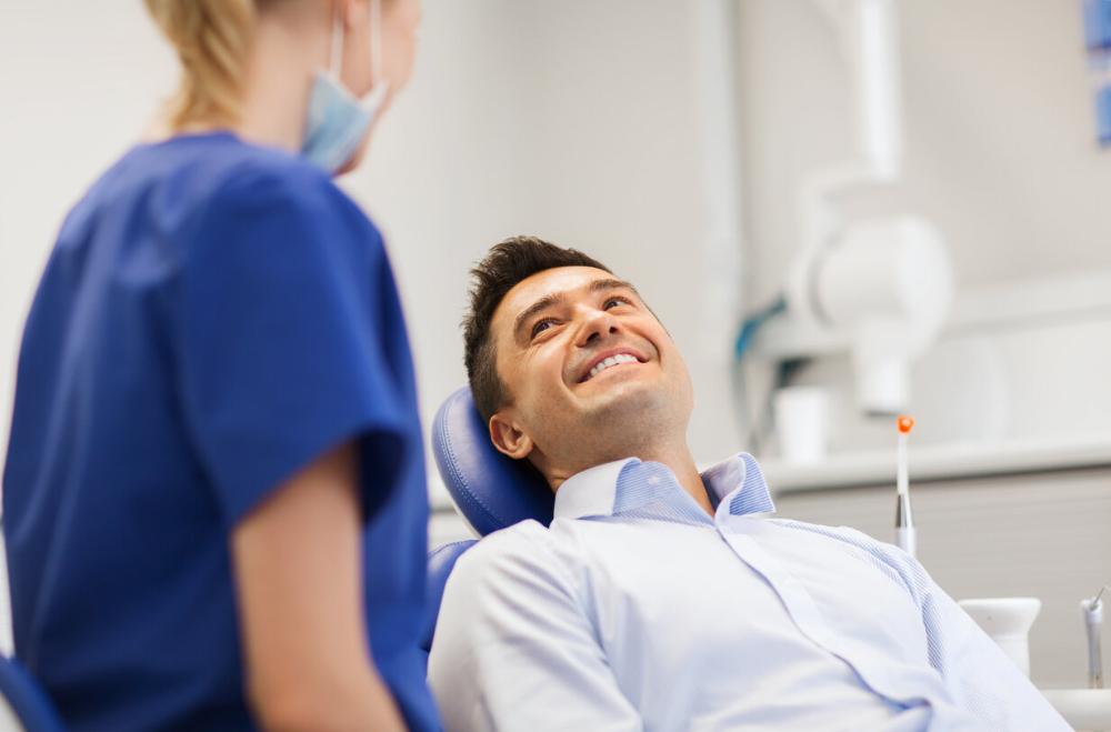 man sitting in dental chair in lincoln