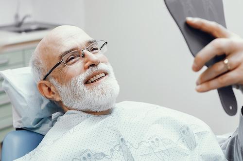Lincoln man smiling after getting dentures