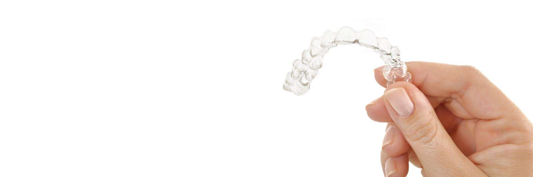 Hand holding up tray of Invisalign in Lincoln, NE