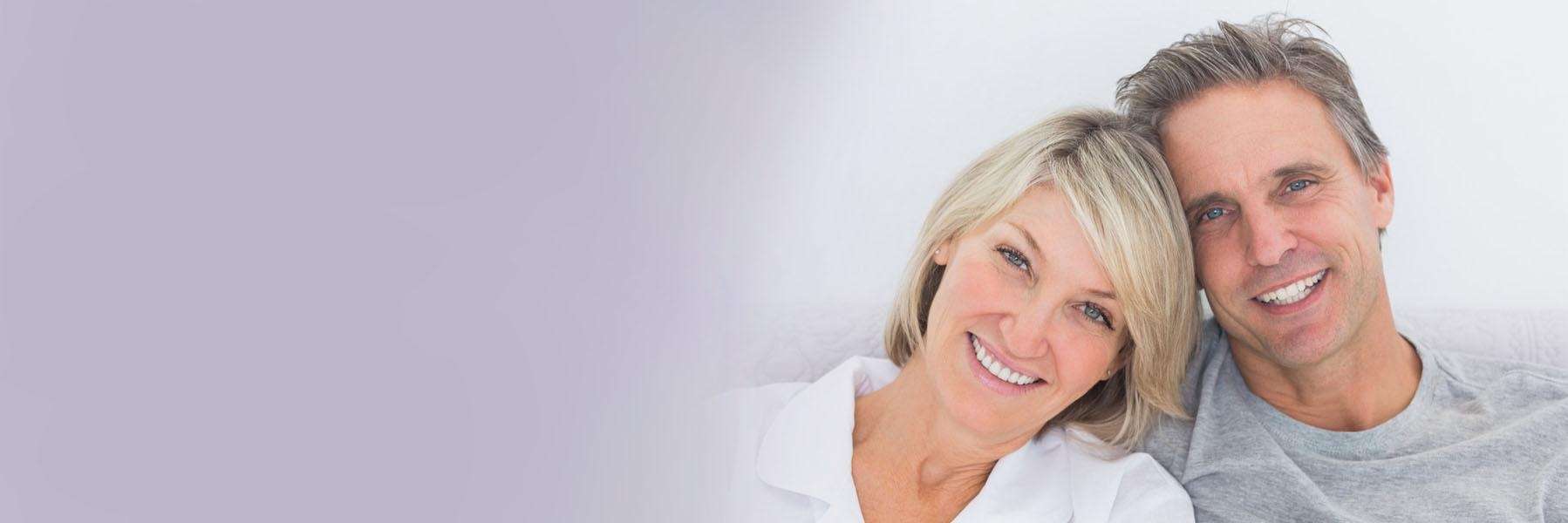 Middle aged woman and man smiling 