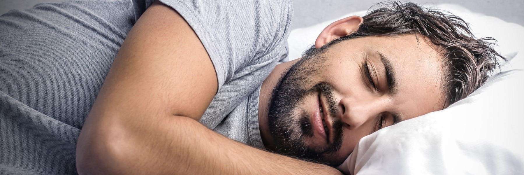 man sleeping soundly after starting treatment for sleep apnea