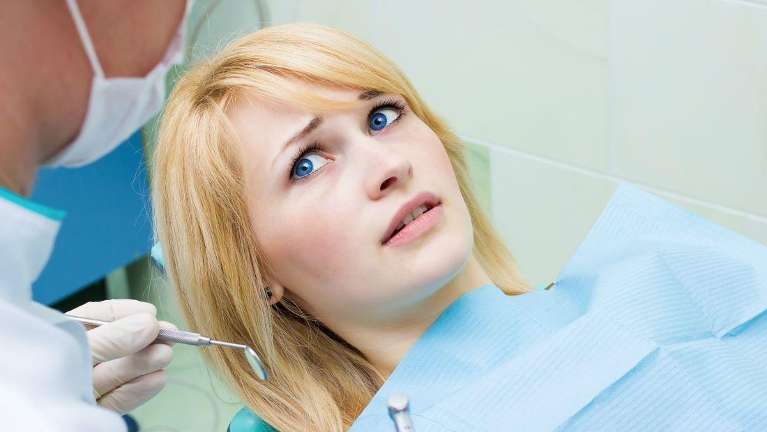 anxious patient in dental chair 
