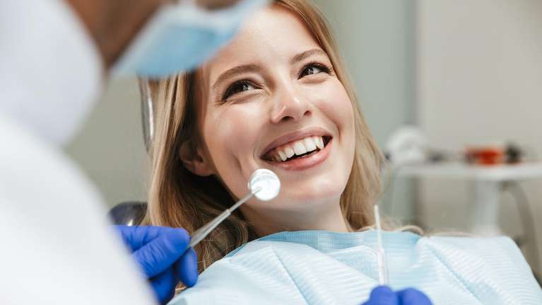 woman smiling in Lincoln dental chair