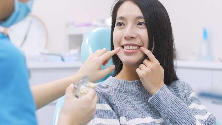 woman sitting in dental chair during exam in lincoln