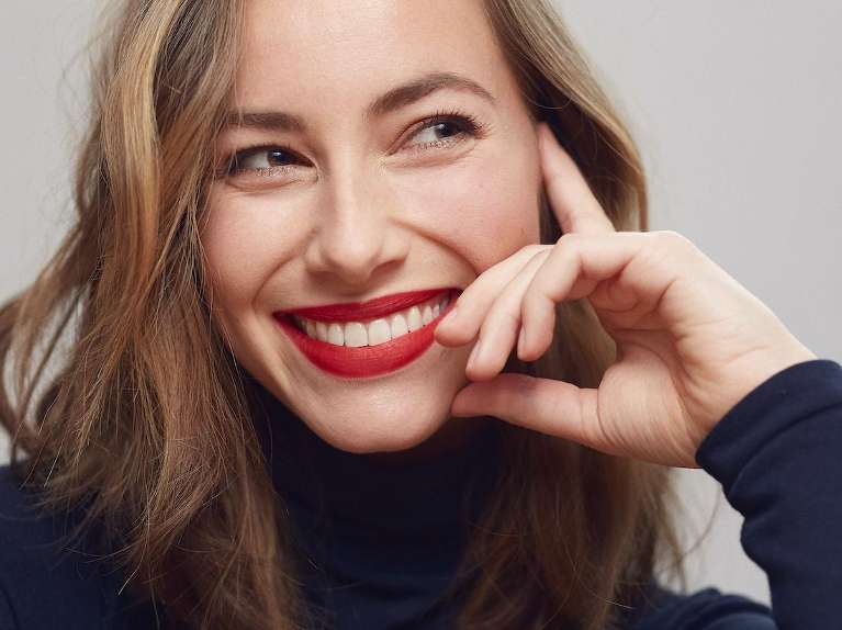 Woman smiling after getting dental veneers in Lincoln