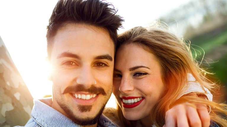 man and woman smiling in Lincoln NE park