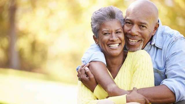 middle-aged man and woman hugging in a park