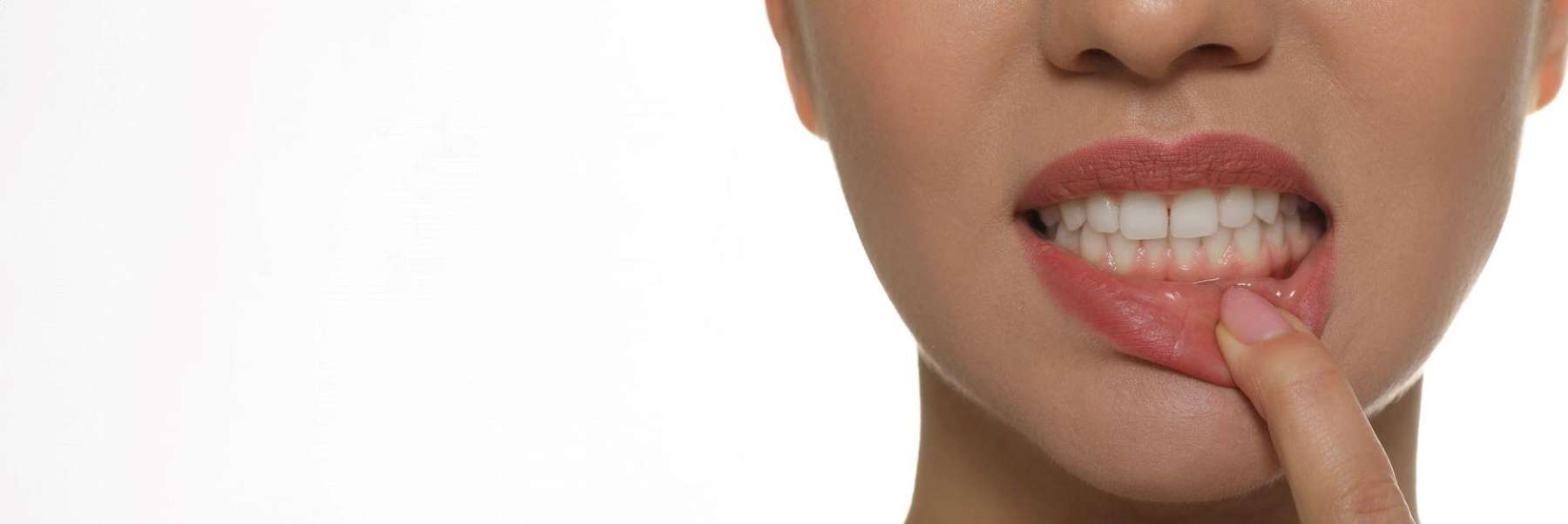 woman pulling lip down to show teeth