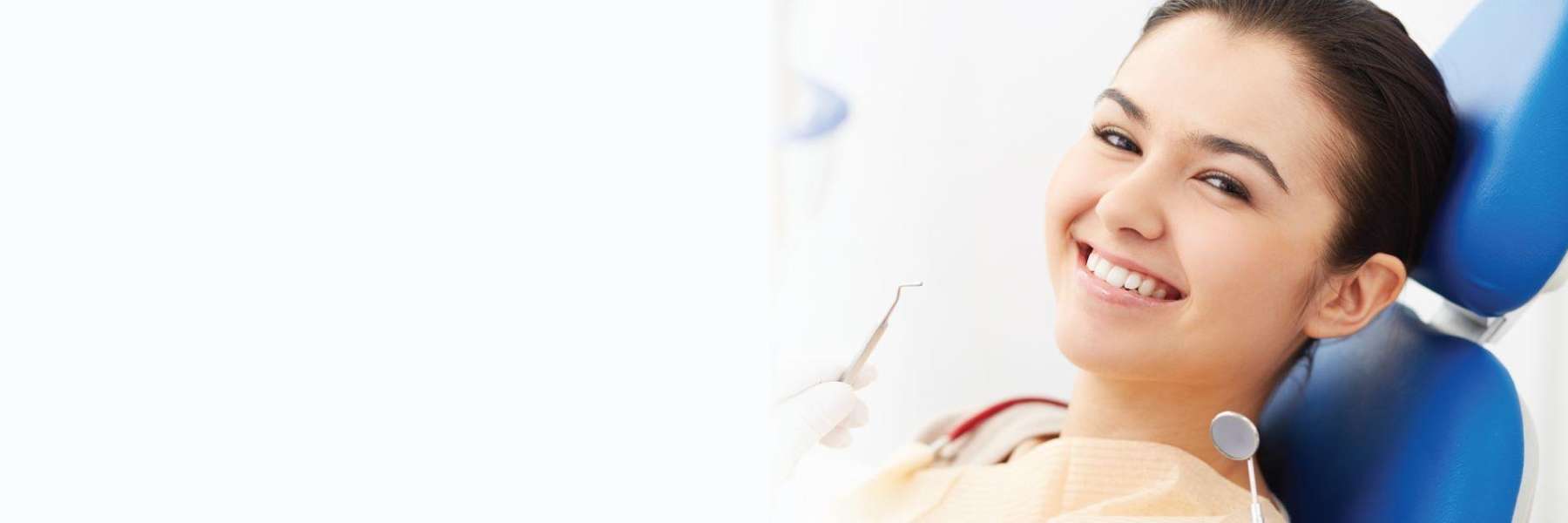 woman smiling in dental chair after getting filling in lincoln 
