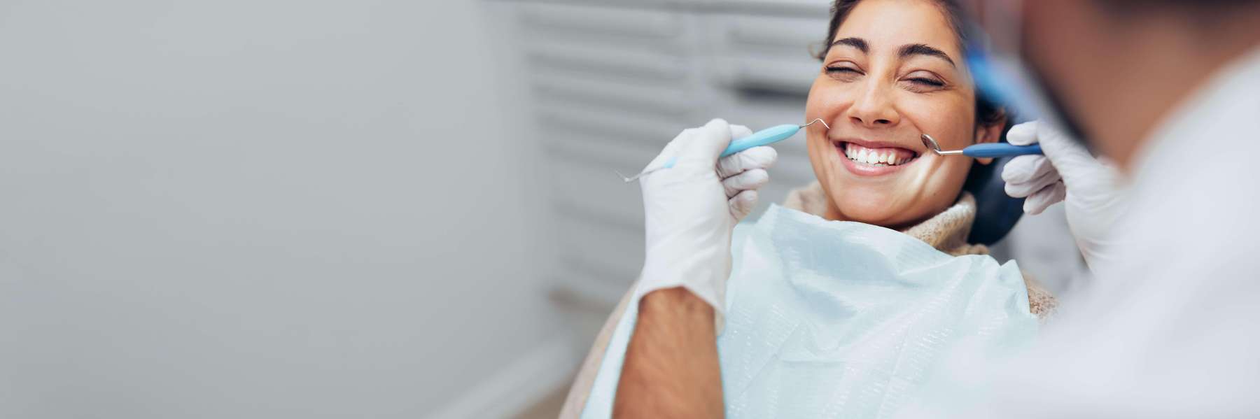 Woman smiling in chair at dentist near me Lincoln, NE