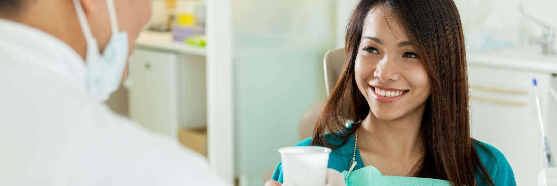 Smiling patient talking with dentist during oral health checkup at Antelope Creek Family Dentistry i