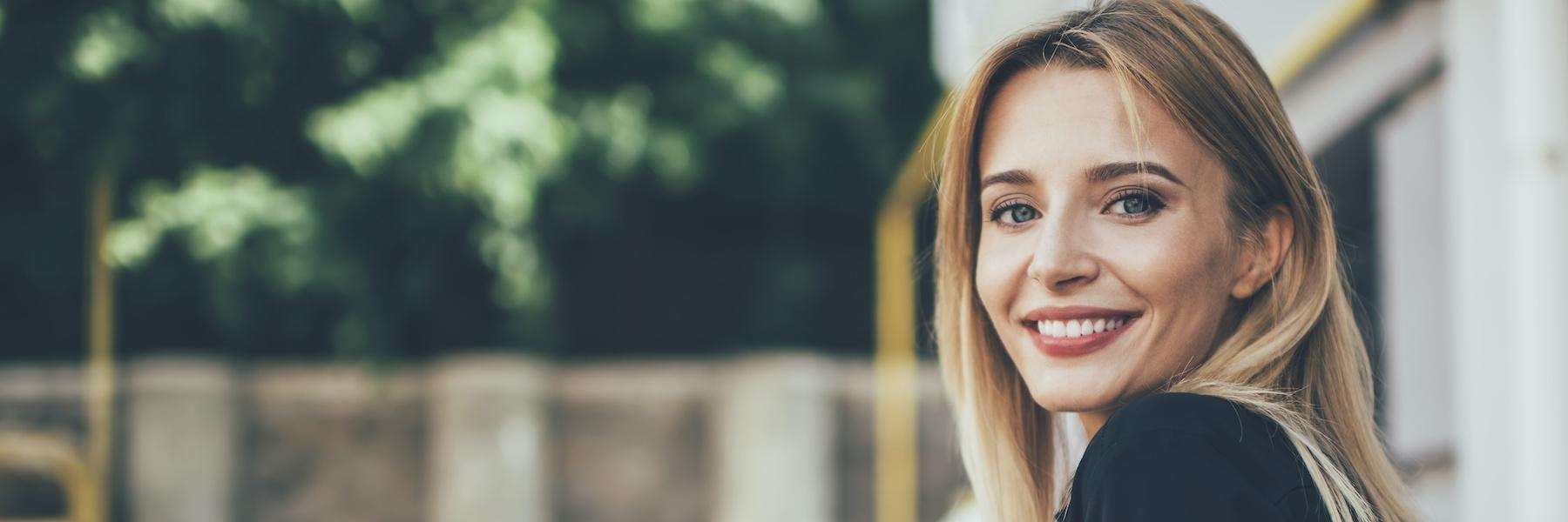 Woman with dental crowns smiling in Lincoln, NE
